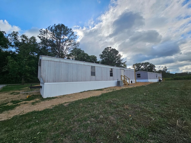 view of side of home with a yard