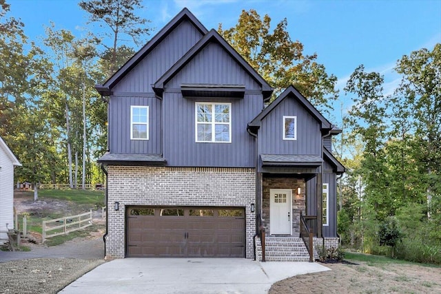 view of front facade with brick siding, board and batten siding, fence, a garage, and driveway