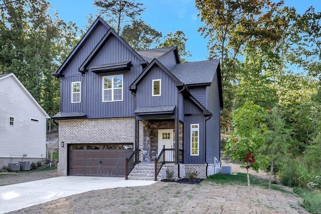 view of front of house with driveway, a garage, central AC unit, and roof with shingles