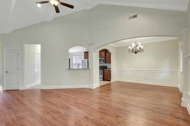 unfurnished living room with ceiling fan with notable chandelier, light hardwood / wood-style floors, and high vaulted ceiling