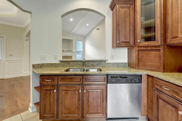 kitchen with light hardwood / wood-style floors, light stone countertops, stainless steel dishwasher, ornamental molding, and sink