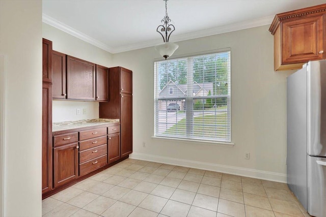 kitchen with pendant lighting, crown molding, light tile patterned floors, and stainless steel fridge