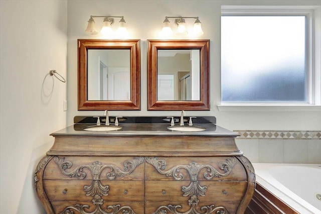 bathroom featuring vanity, plenty of natural light, and a relaxing tiled tub