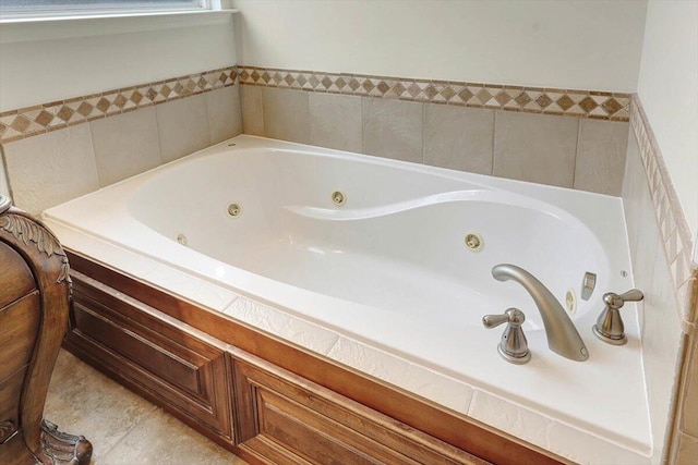 bathroom featuring tile patterned flooring and a tub to relax in