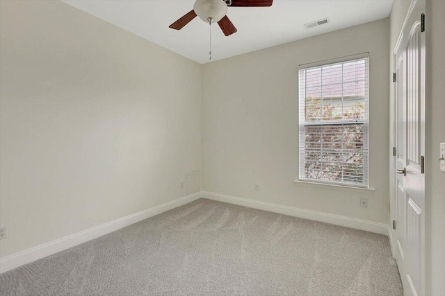 empty room with ceiling fan and light colored carpet