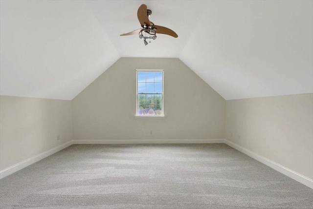 additional living space featuring light carpet, vaulted ceiling, and ceiling fan