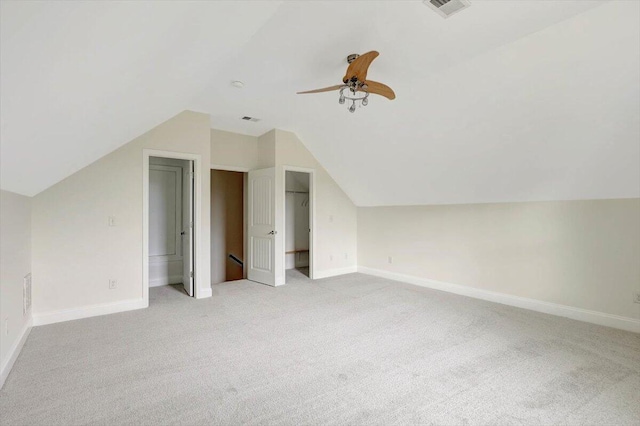 bonus room featuring light colored carpet and vaulted ceiling