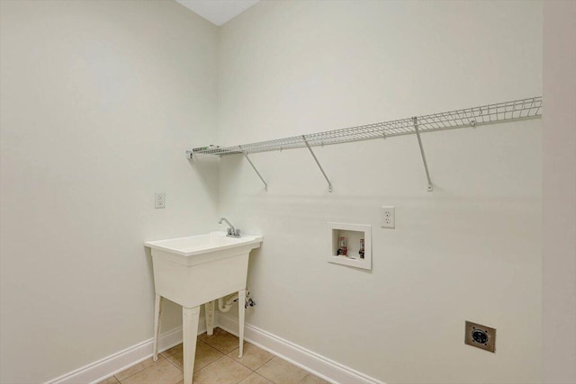 clothes washing area featuring hookup for an electric dryer, hookup for a washing machine, and light tile patterned floors