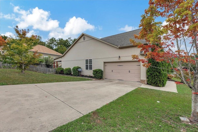 view of side of home with a garage and a lawn