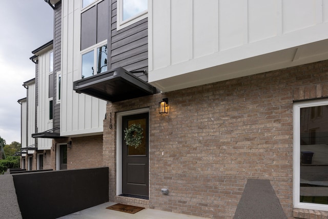 entrance to property featuring board and batten siding