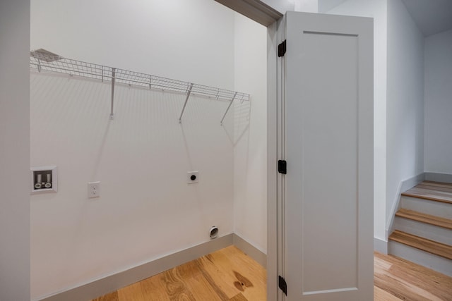 laundry room with washer hookup, electric dryer hookup, light wood-style floors, baseboards, and laundry area