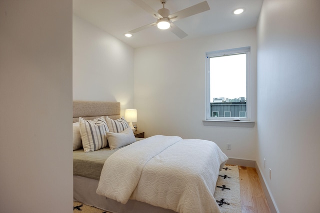 bedroom with baseboards, recessed lighting, a ceiling fan, and light wood finished floors