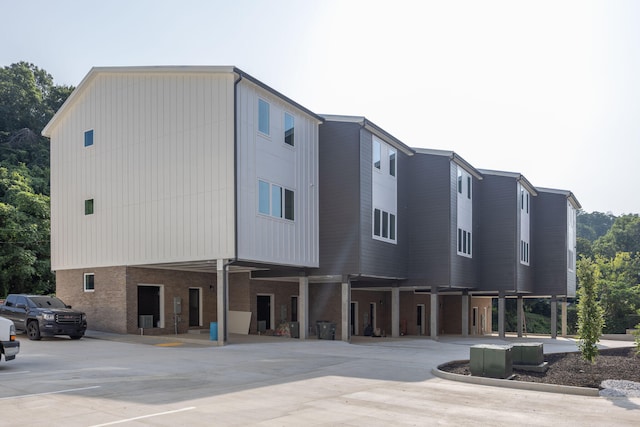 view of building exterior with a carport and driveway