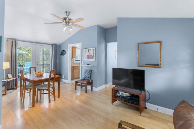 dining room with light wood-type flooring, lofted ceiling, ceiling fan, and french doors