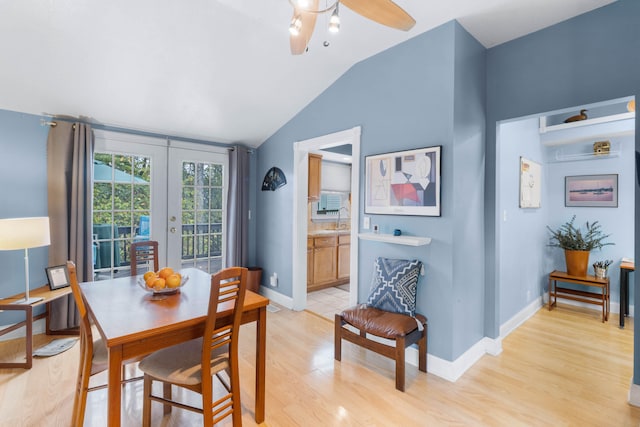 dining room featuring vaulted ceiling, ceiling fan, light hardwood / wood-style flooring, and french doors