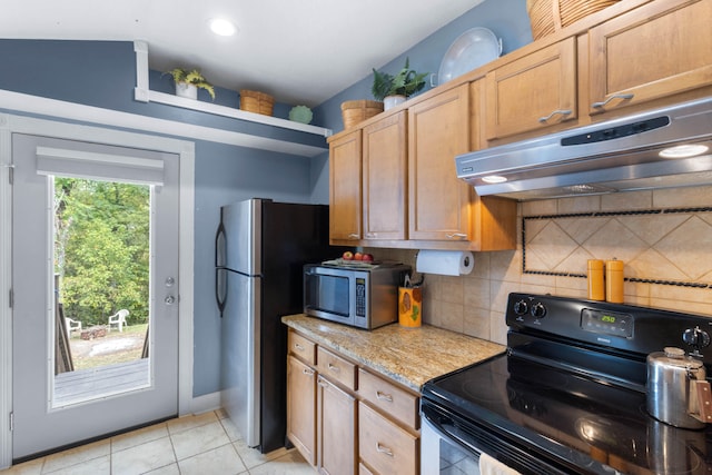 kitchen with appliances with stainless steel finishes, decorative backsplash, light tile patterned floors, and light stone counters