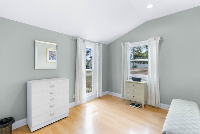 bedroom with vaulted ceiling and light hardwood / wood-style floors