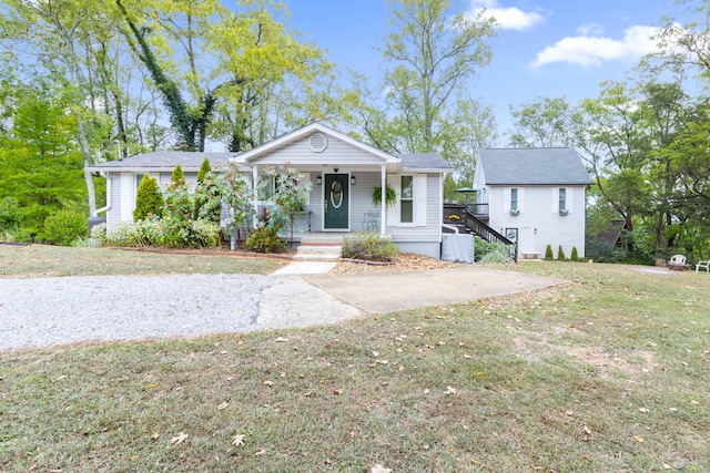 view of front of house with a front yard and a porch