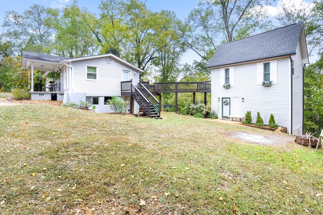 rear view of house with a lawn and a deck