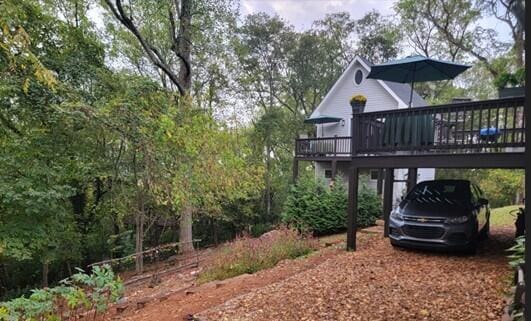 exterior space with a carport and a deck