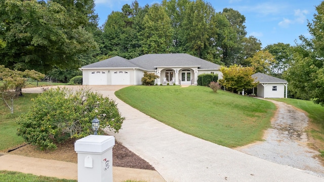 single story home with a garage and a front lawn