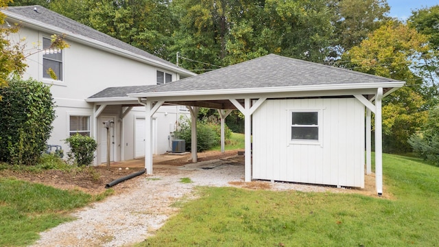 view of outbuilding with central AC and a yard