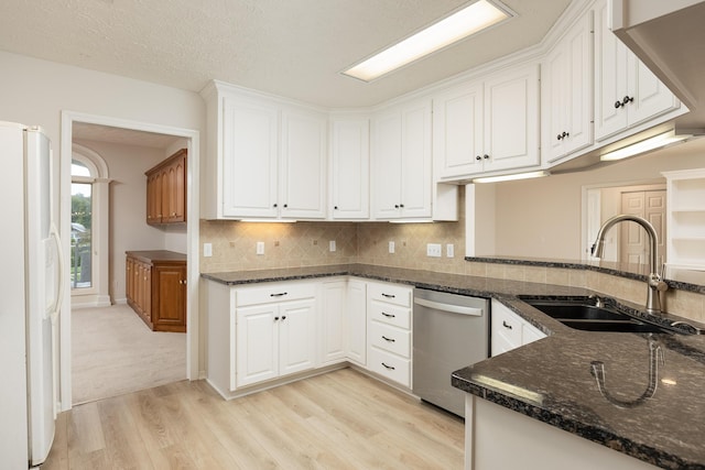 kitchen with white cabinets, dishwasher, and white refrigerator