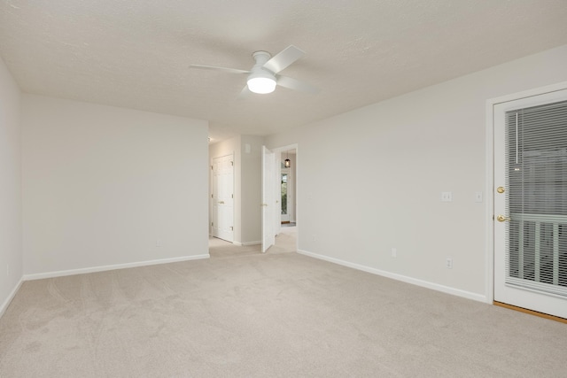 carpeted spare room with ceiling fan and a textured ceiling