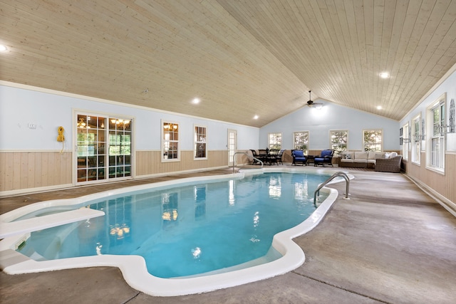 view of pool featuring ceiling fan and a diving board