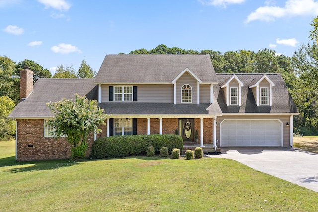 view of front of property with a garage, covered porch, and a front yard