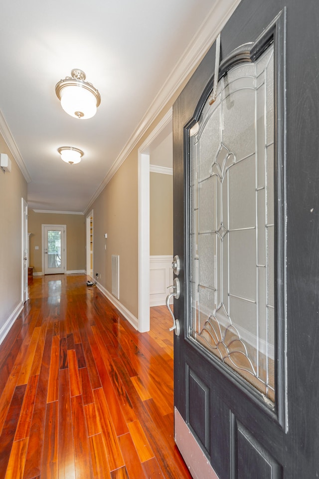 foyer entrance featuring wood-type flooring and ornamental molding