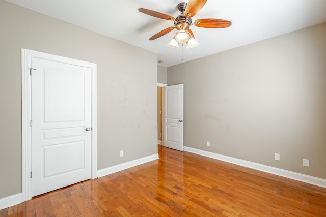 unfurnished bedroom featuring ceiling fan and hardwood / wood-style flooring