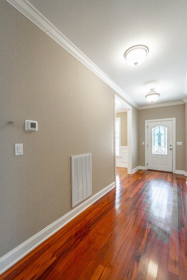 unfurnished room featuring crown molding and dark hardwood / wood-style flooring