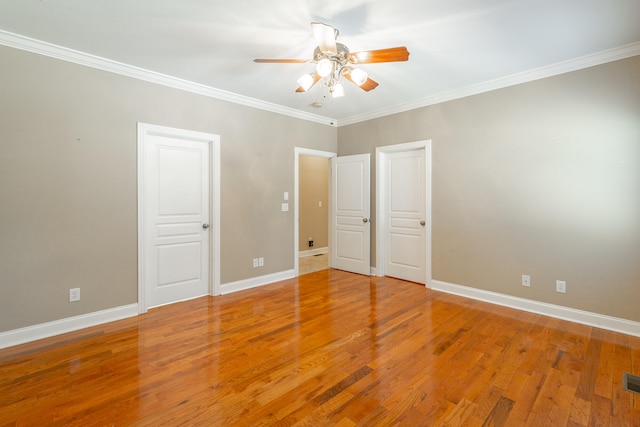 unfurnished bedroom with ceiling fan, ornamental molding, and hardwood / wood-style floors