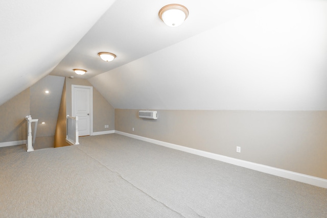 bonus room featuring vaulted ceiling, carpet, and a wall mounted AC