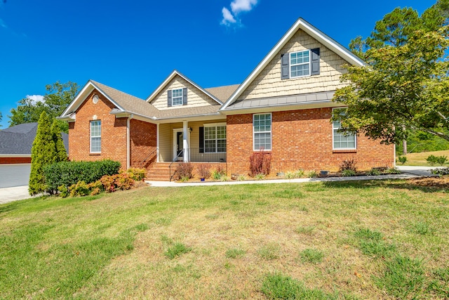 craftsman house featuring a garage, a porch, and a front lawn