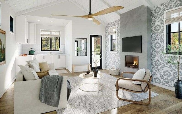 living room with beam ceiling, a fireplace, light hardwood / wood-style floors, and plenty of natural light