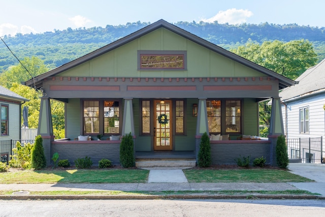 view of front facade featuring a mountain view and a porch