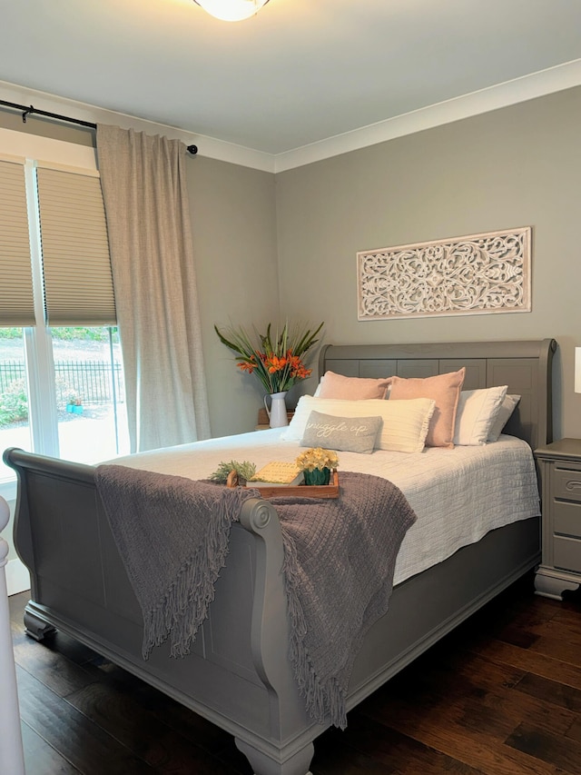 bedroom featuring dark hardwood / wood-style floors and crown molding