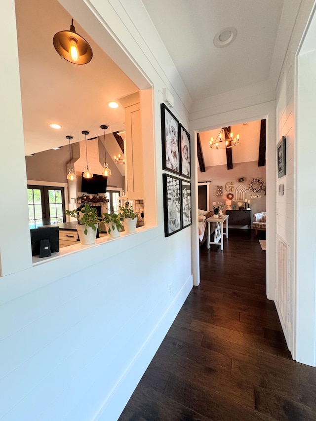 hall with lofted ceiling and dark hardwood / wood-style floors