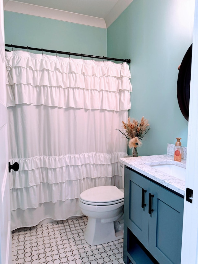 bathroom featuring tile patterned floors, curtained shower, vanity, and toilet