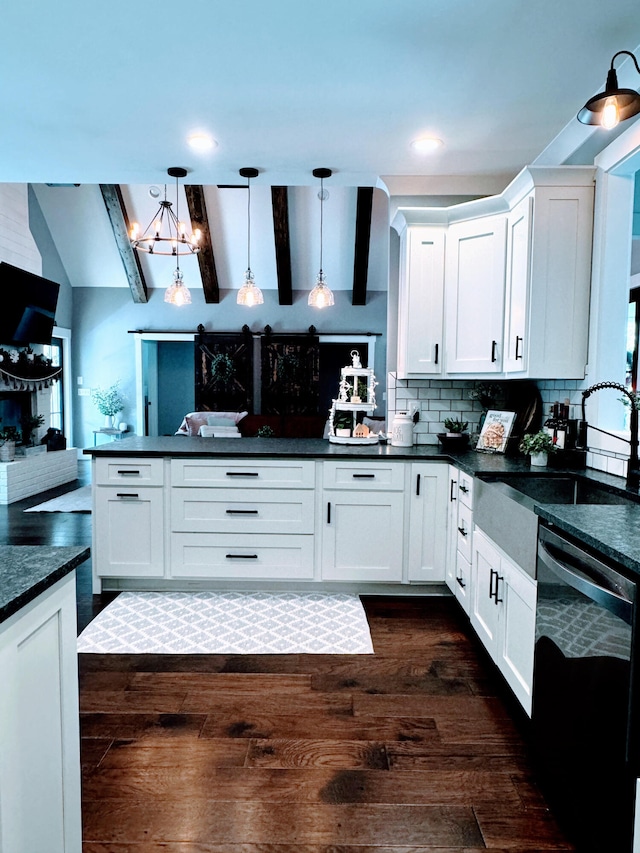 kitchen with dishwasher, beamed ceiling, white cabinetry, and hanging light fixtures