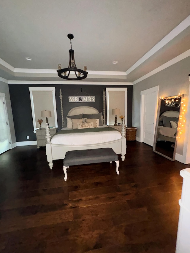 bedroom featuring crown molding and dark hardwood / wood-style flooring