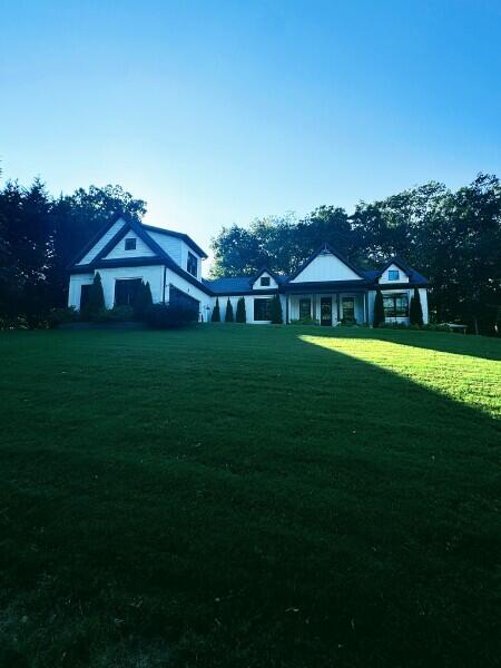 rear view of property with a yard