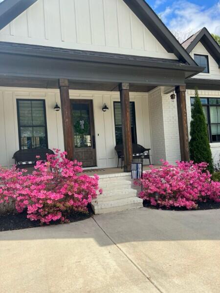 view of exterior entry with covered porch