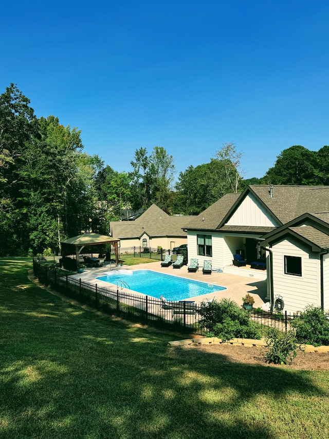 view of swimming pool featuring a patio area and a yard