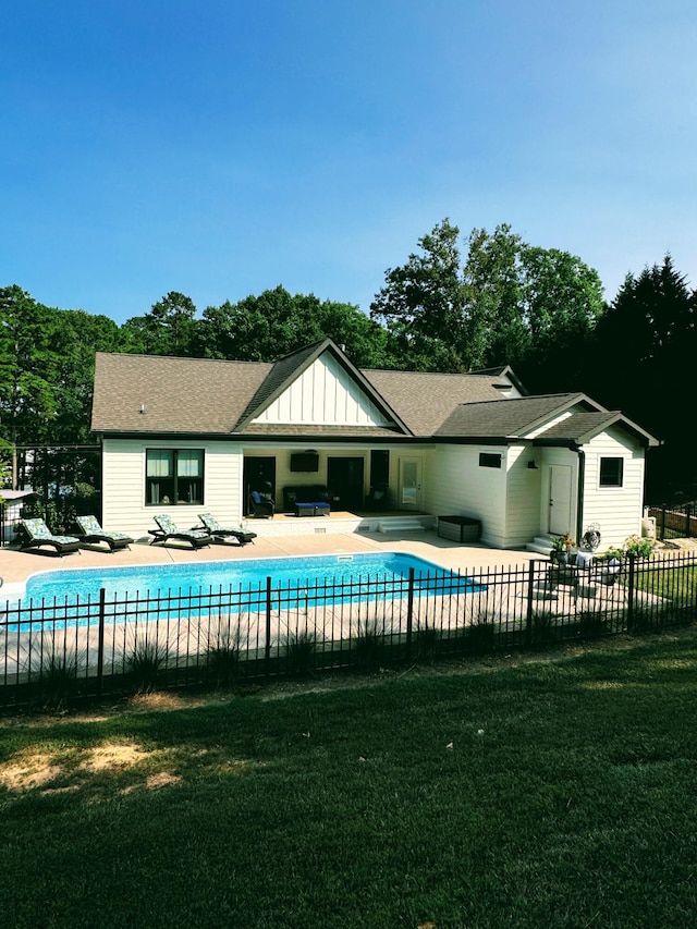 view of swimming pool featuring a lawn and a patio area