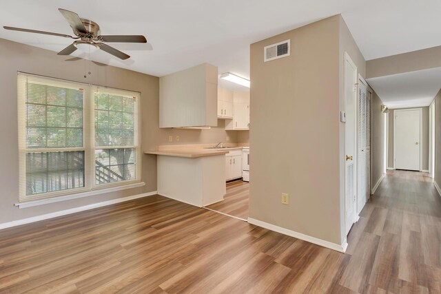 kitchen featuring white cabinetry, ceiling fan, and light hardwood / wood-style flooring