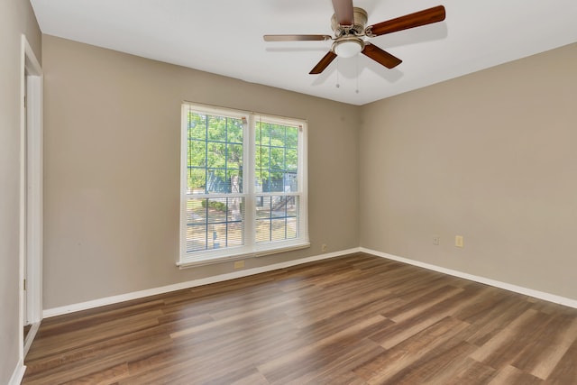 spare room with ceiling fan and dark hardwood / wood-style floors