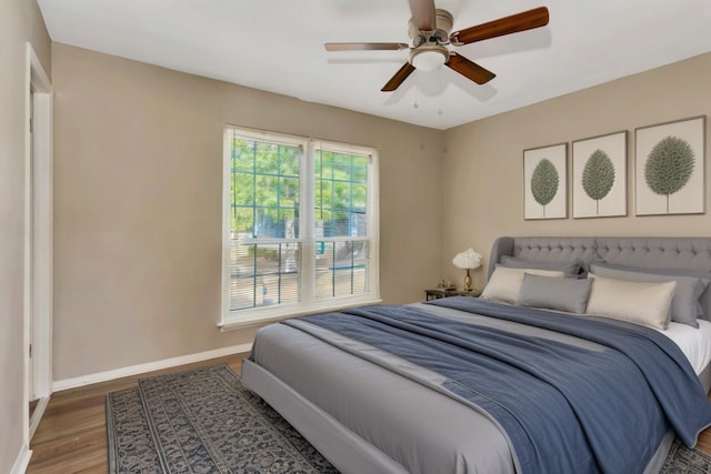 bedroom featuring ceiling fan and dark hardwood / wood-style flooring